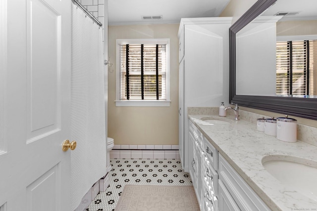 3 Dan Beard Ln, Redding, CT 06896 - full bath featuring double vanity, plenty of natural light, toilet, crown molding, and tile patterned flooring