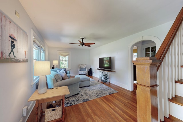 1 Yale Ave, Middlebury, CT 06762 - living area featuring wood finished floors, arched walkways, ceiling fan, stairway, and baseboards