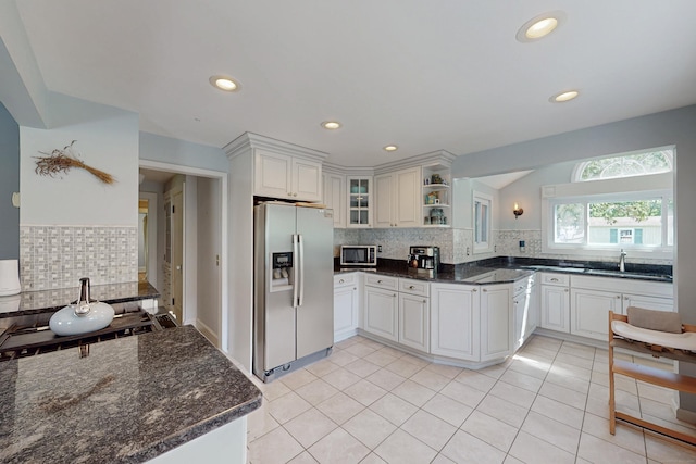 1 Yale Ave, Middlebury, CT 06762 - kitchen featuring appliances with stainless steel finishes, open shelves, backsplash, glass insert cabinets, and dark stone counters