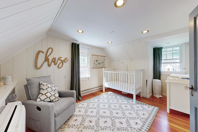 1 Yale Ave, Middlebury, CT 06762 - bedroom with baseboard heating, vaulted ceiling, wood finished floors, recessed lighting, and a decorative wall