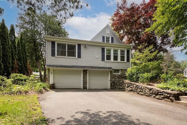 1 Yale Ave, Middlebury, CT 06762 - view of front of house with driveway, a garage, and stone siding