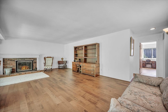 living room with wood finished floors and a fireplace