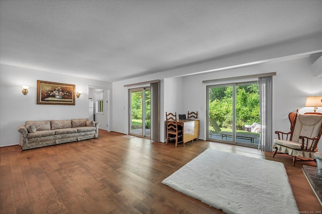 living room with wood finished floors and a textured ceiling