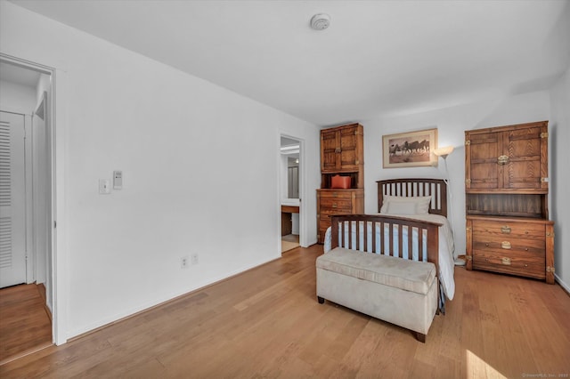 bedroom with light wood-style floors and baseboards