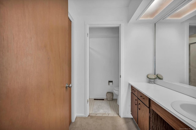 bathroom with toilet and vanity