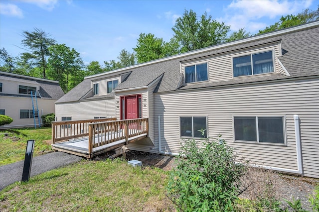 view of front of property with a wooden deck and a shingled roof