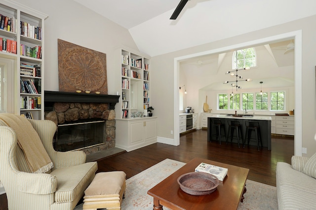 171 Cross Hwy, Redding, CT 06896 - living room with lofted ceiling, dark wood-style flooring, a ceiling fan, a fireplace, and built in shelves
