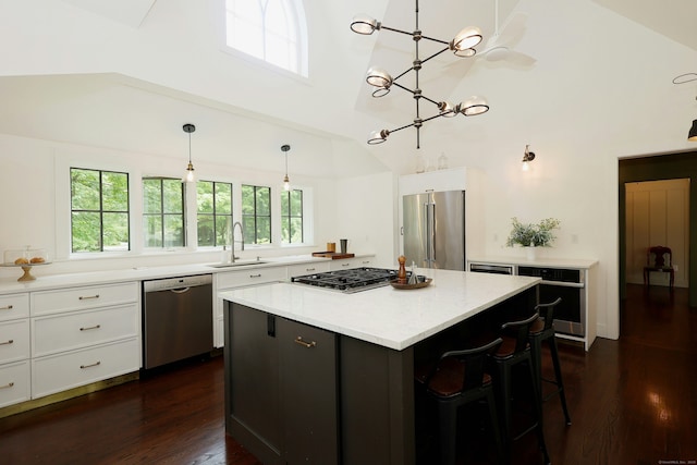 171 Cross Hwy, Redding, CT 06896 - kitchen featuring appliances with stainless steel finishes, dark wood-style flooring, plenty of natural light, white cabinets, and high vaulted ceiling
