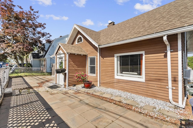 100 Boston Ter, Bridgeport, CT 06610 - back of property with a patio, a chimney, roof with shingles, and an outdoor structure