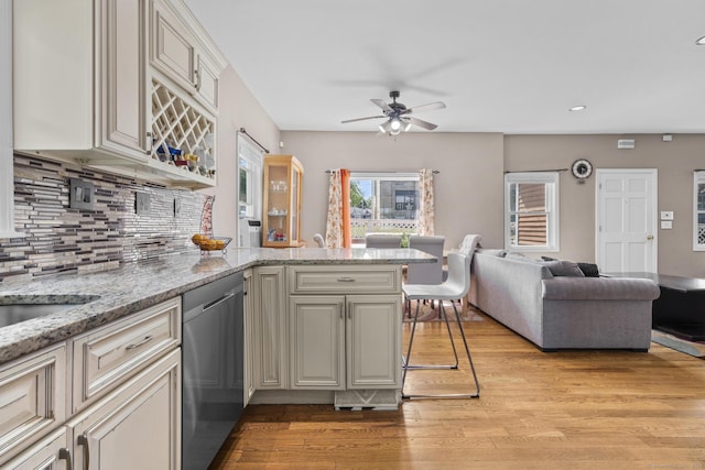 100 Boston Ter, Bridgeport, CT 06610 - kitchen with stainless steel dishwasher, open floor plan, light wood-style floors, ceiling fan, and a peninsula