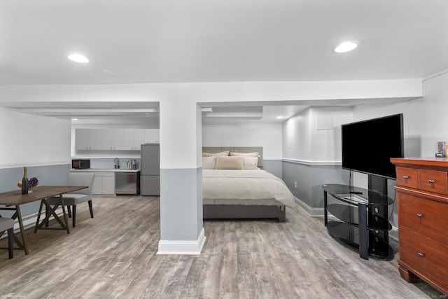 100 Boston Ter, Bridgeport, CT 06610 - bedroom with freestanding refrigerator, wood finished floors, baseboards, recessed lighting, and a sink