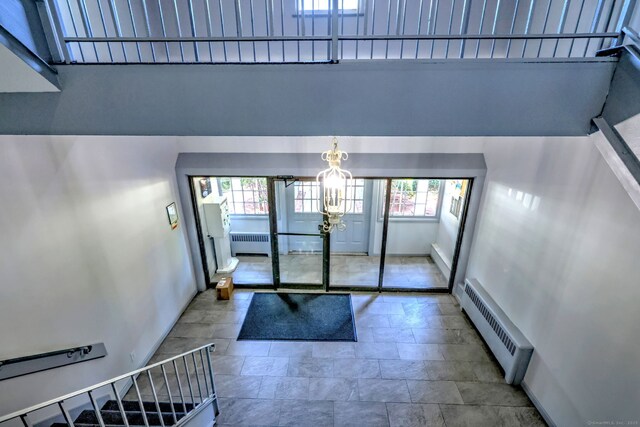 1120 New Haven Ave Apt 142, Milford, CT 06460 - unfurnished living room with a baseboard radiator, healthy amount of natural light, radiator, and stone finish flooring