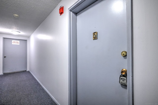 1120 New Haven Ave Apt 142, Milford, CT 06460 - hallway featuring a textured ceiling, carpet flooring, and baseboards