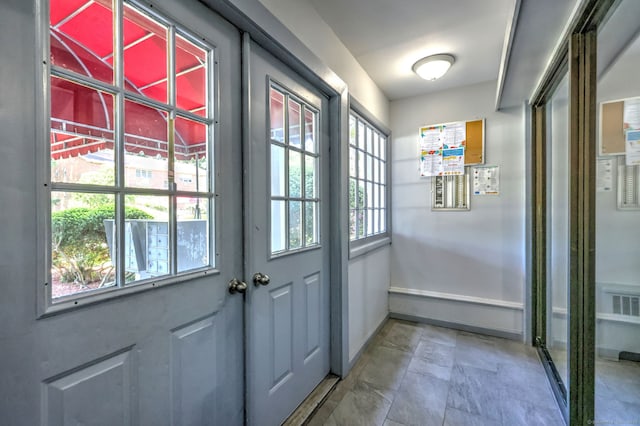 1120 New Haven Ave Apt 142, Milford, CT 06460 - doorway to outside featuring baseboards and light stone finish flooring