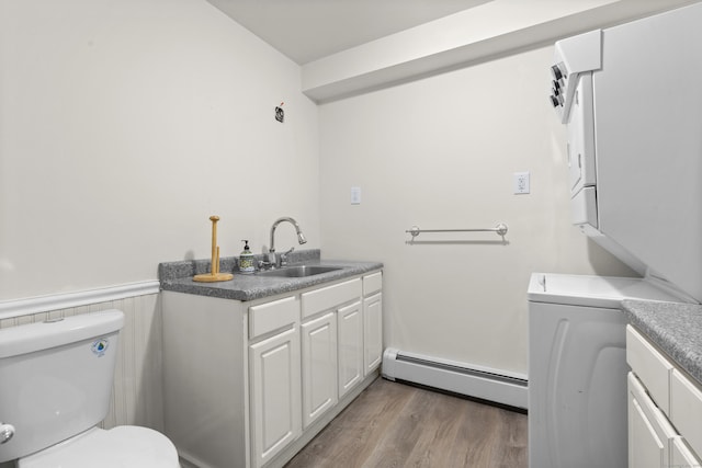 4 Wanzer Hill Rd, Sherman, CT 06784 - half bath featuring a baseboard heating unit, toilet, wainscoting, wood finished floors, and vanity