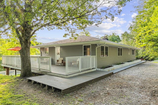 4 Wanzer Hill Rd, Sherman, CT 06784 - back of property with a deck and a chimney