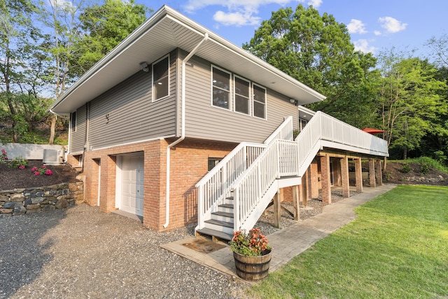 4 Wanzer Hill Rd, Sherman, CT 06784 - back of property featuring brick siding, stairs, a deck, a lawn, and central AC unit
