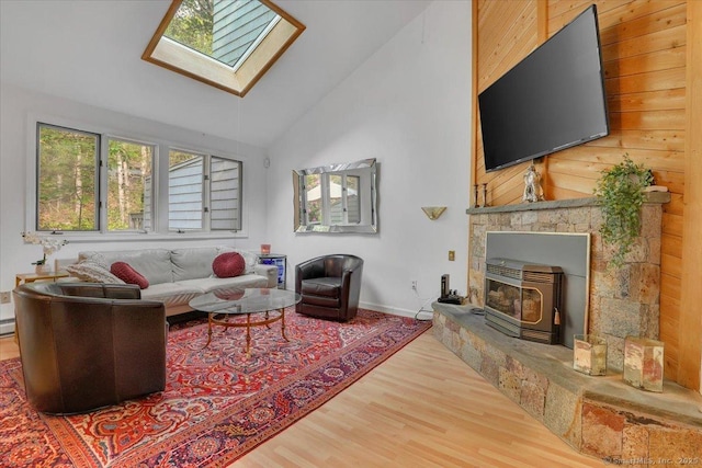 424 Trailsend Dr Unit 424, Torrington, CT 06790 - living area with a skylight, wood finished floors, baseboards, a wood stove, and wood walls