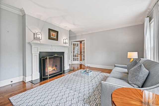 6 Coachlamp Ln, Greenwich, CT 06830 - living room featuring dark wood-style floors, baseboards, ornamental molding, and a warm lit fireplace