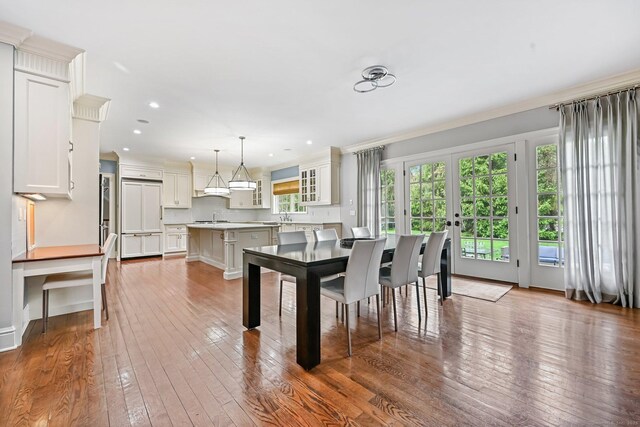6 Coachlamp Ln, Greenwich, CT 06830 - dining space featuring dark wood-type flooring, crown molding, recessed lighting, and french doors