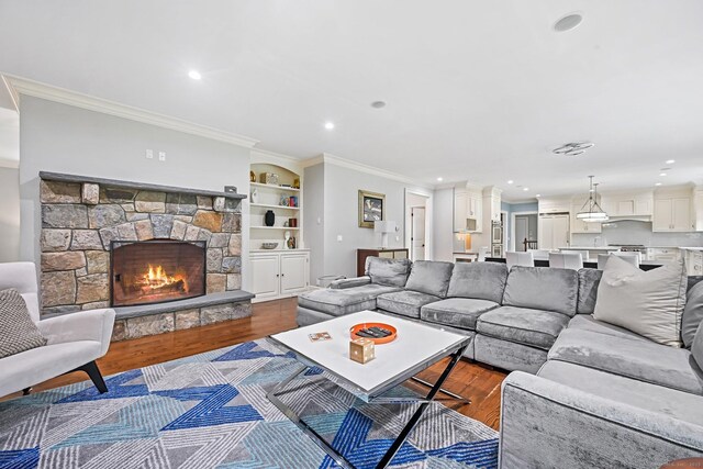 6 Coachlamp Ln, Greenwich, CT 06830 - living area featuring dark wood-style floors, crown molding, recessed lighting, and a stone fireplace