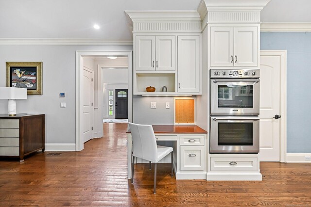 6 Coachlamp Ln, Greenwich, CT 06830 - kitchen featuring stainless steel double oven, baseboards, ornamental molding, dark wood finished floors, and white cabinets
