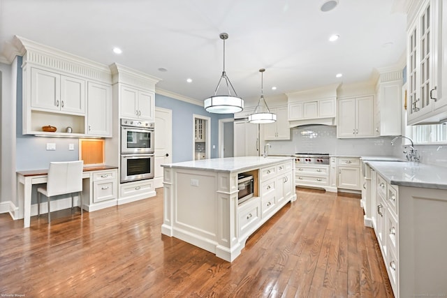 6 Coachlamp Ln, Greenwich, CT 06830 - kitchen with appliances with stainless steel finishes, a sink, decorative backsplash, white cabinetry, and ornamental molding