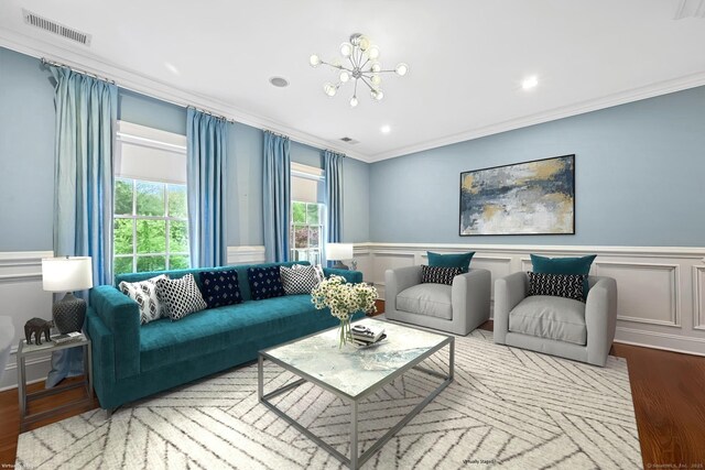 6 Coachlamp Ln, Greenwich, CT 06830 - living area featuring ornamental molding, wood finished floors, a chandelier, wainscoting, and a decorative wall