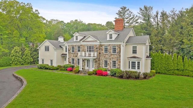 6 Coachlamp Ln, Greenwich, CT 06830 - colonial house featuring stone siding, a chimney, a front yard, and driveway
