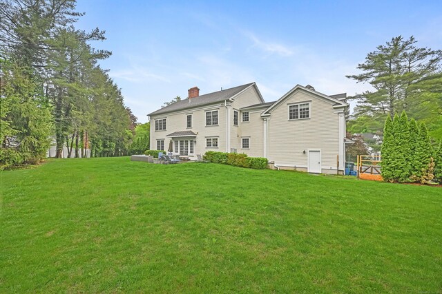 6 Coachlamp Ln, Greenwich, CT 06830 - back of house with a yard, a chimney, and an outdoor living space