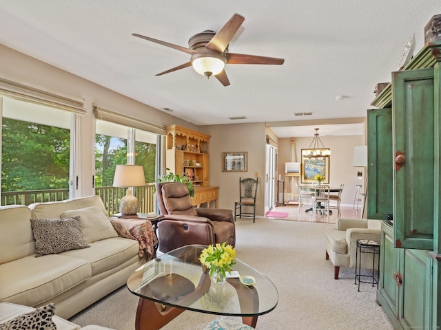 100 Wolfpit Ave Apt 19, Norwalk, CT 06851 - living room with a ceiling fan, light carpet, a chandelier, and a textured ceiling