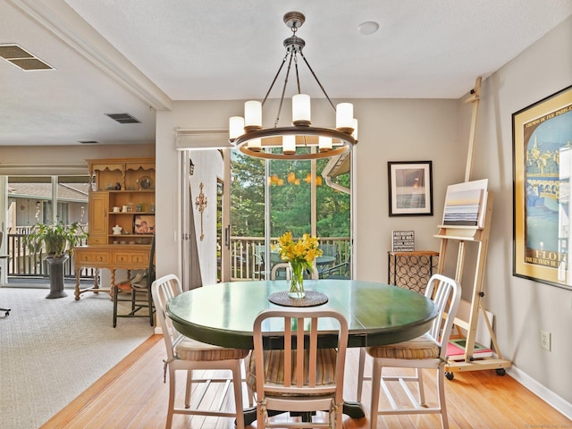 100 Wolfpit Ave Apt 19, Norwalk, CT 06851 - dining room with light wood-style floors, baseboards, and a chandelier
