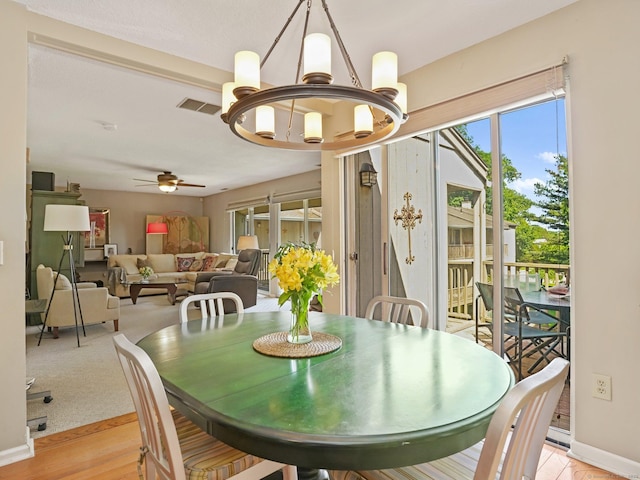 100 Wolfpit Ave Apt 19, Norwalk, CT 06851 - dining room featuring a chandelier, ceiling fan, baseboards, and light wood-style flooring