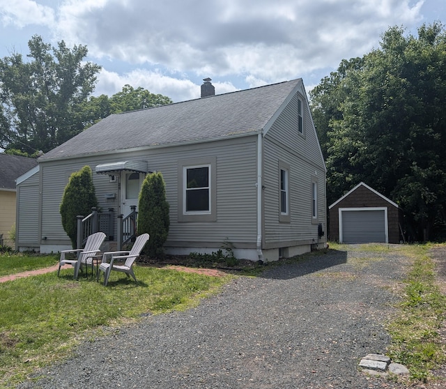 26 Westfield St, Manchester, CT 06042 - view of front of home with a chimney, an outdoor structure, roof with shingles, and a garage