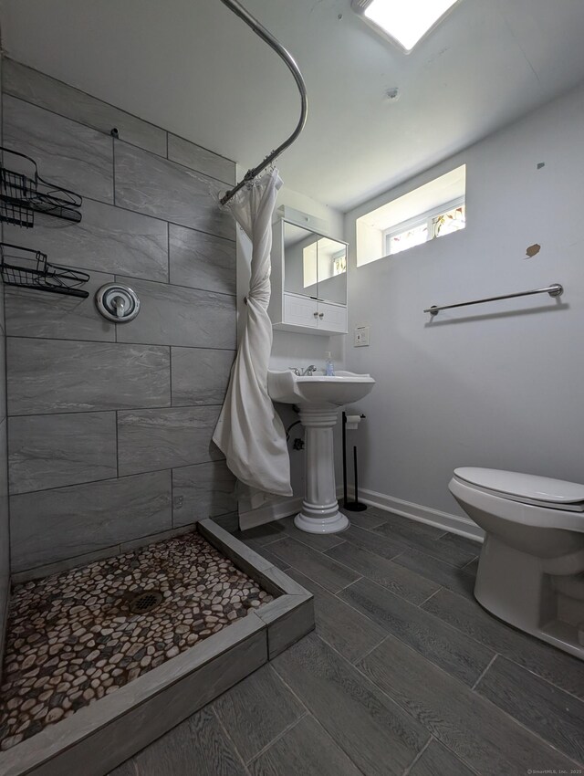 26 Westfield St, Manchester, CT 06042 - full bathroom with a stall shower, toilet, wood tiled floors, and baseboards