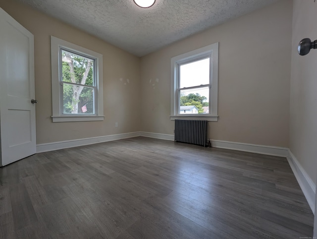 26 Westfield St, Manchester, CT 06042 - unfurnished room with radiator, a textured ceiling, wood finished floors, and baseboards