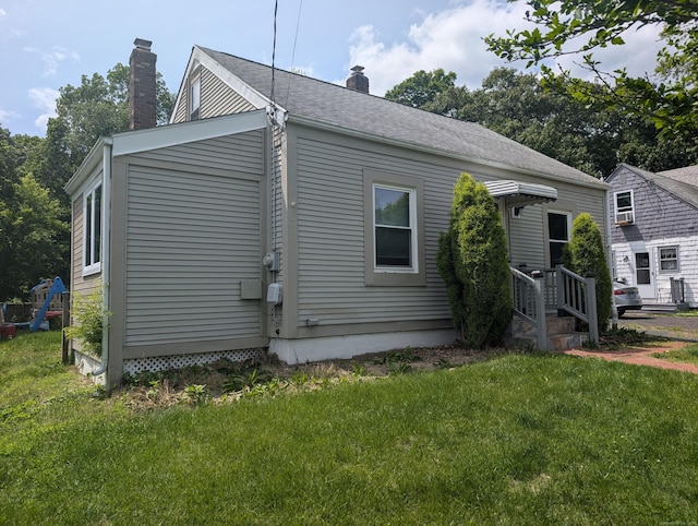 26 Westfield St, Manchester, CT 06042 - view of home's exterior featuring a chimney and a lawn