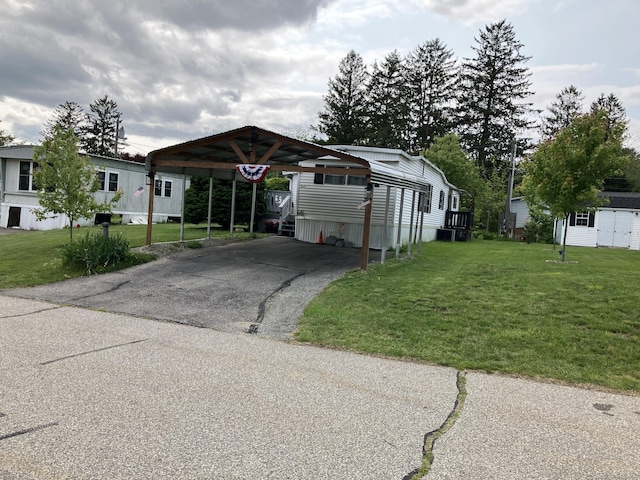 80 Sheldon Rd Lot 12, Griswold, CT 06351 - manufactured / mobile home featuring a carport, driveway, and a front lawn