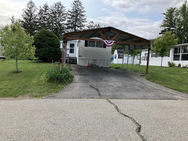 80 Sheldon Rd Lot 12, Griswold, CT 06351 - manufactured / mobile home with a carport, a front yard, and asphalt driveway