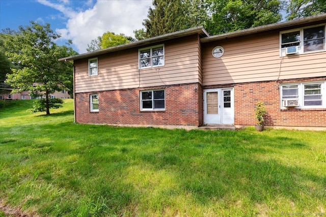 270 S Windham Rd Apt 61, Windham, CT 06226 - rear view of property with brick siding and a lawn