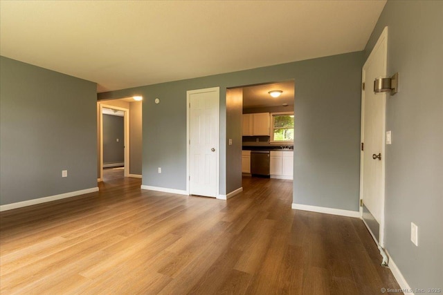 270 S Windham Rd Apt 61, Windham, CT 06226 - unfurnished living room with wood finished floors, baseboards, and a baseboard heating unit