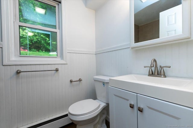 270 S Windham Rd Apt 61, Windham, CT 06226 - bathroom with baseboard heating, vanity, toilet, and a wainscoted wall