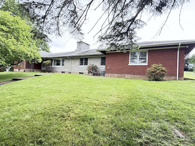 909 Randolph Rd, Middletown, CT 06457 - rear view of property with a yard, a chimney, and brick siding