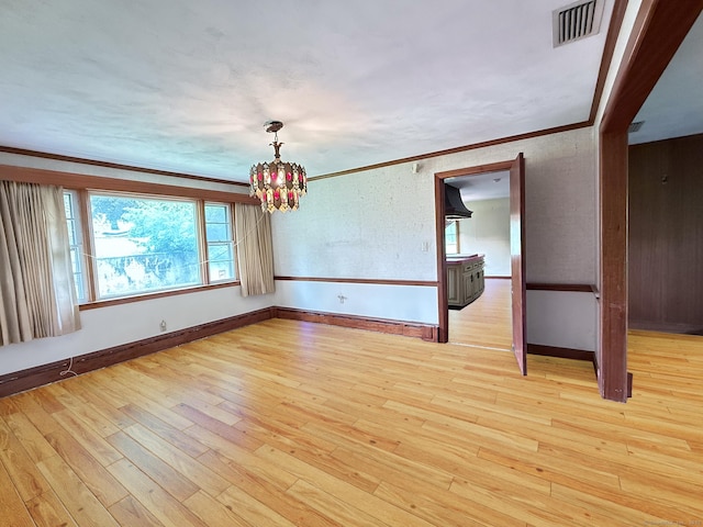 909 Randolph Rd, Middletown, CT 06457 - unfurnished room featuring ornamental molding, a chandelier, light wood-style flooring, and baseboards