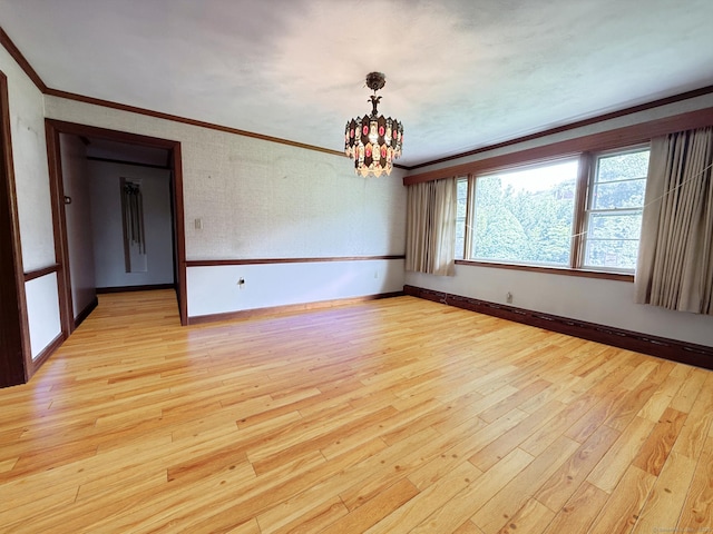 909 Randolph Rd, Middletown, CT 06457 - unfurnished room with crown molding, light wood finished floors, a chandelier, and baseboards