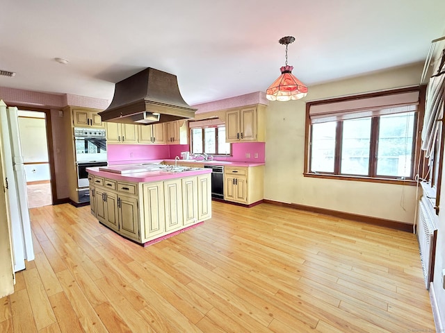 909 Randolph Rd, Middletown, CT 06457 - kitchen with island exhaust hood, dishwasher, white double oven, light countertops, and a kitchen island