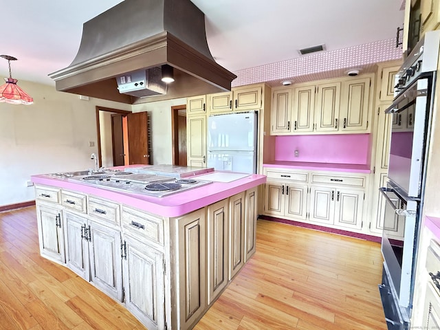 909 Randolph Rd, Middletown, CT 06457 - kitchen with white appliances, light wood-style floors, a center island, and light countertops