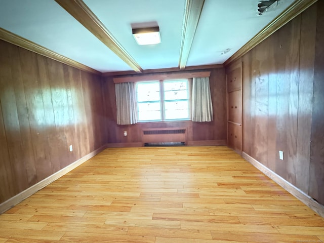 909 Randolph Rd, Middletown, CT 06457 - empty room featuring radiator heating unit, light wood-style floors, beam ceiling, and wooden walls