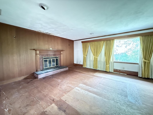 909 Randolph Rd, Middletown, CT 06457 - unfurnished living room with a fireplace, baseboards, and wooden walls