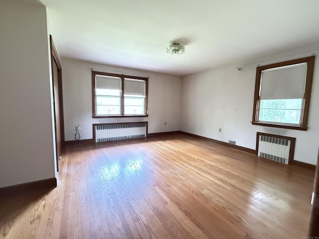 909 Randolph Rd, Middletown, CT 06457 - empty room featuring radiator, healthy amount of natural light, and light wood finished floors